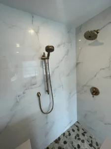 Shower head on marbled shower