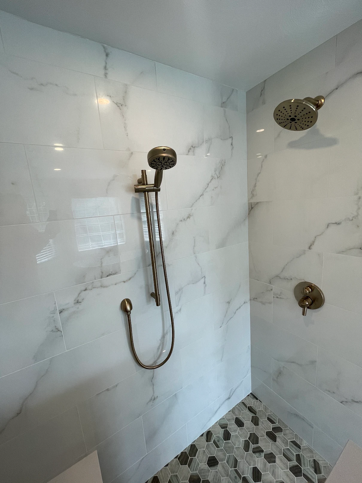 Shower head on marbled shower